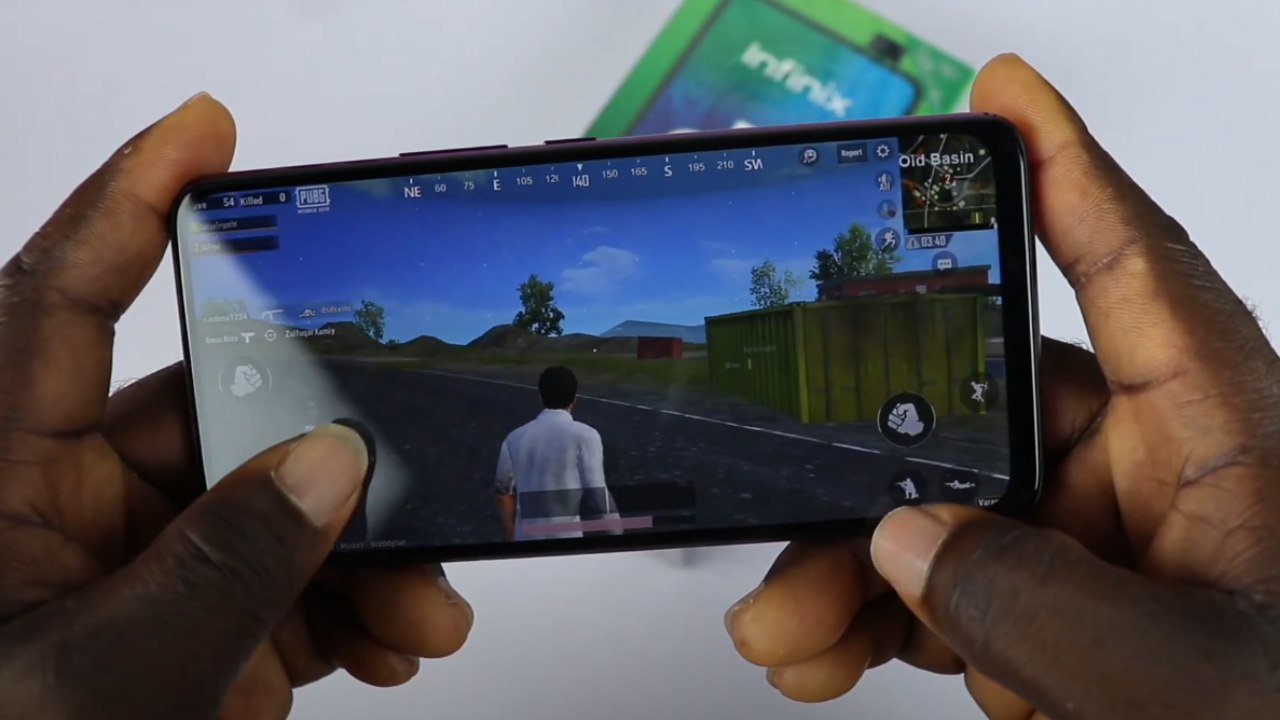 User holding Infinix S5 Pro, playing a graphically demanding game.
